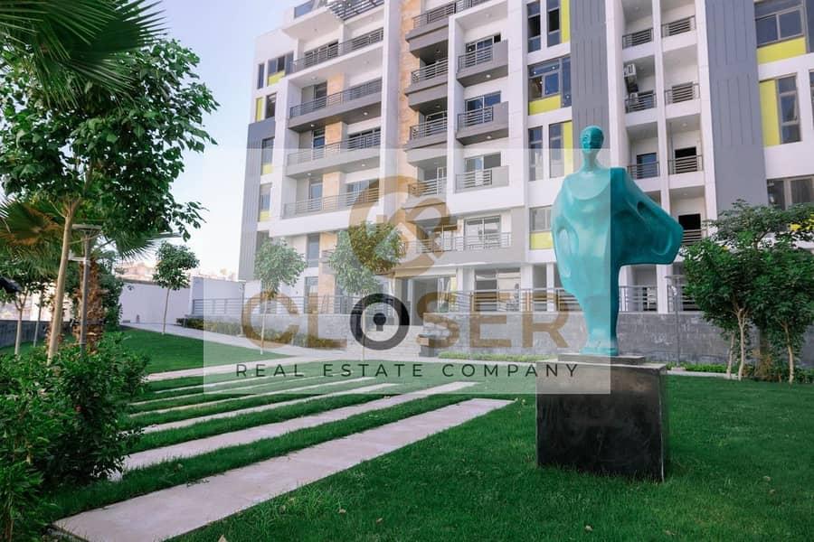 luxury apartment for sale with a premium garden area at half its price with installments over 10 years in ( The Icon ) Compound next to Hyde Park — 1/8